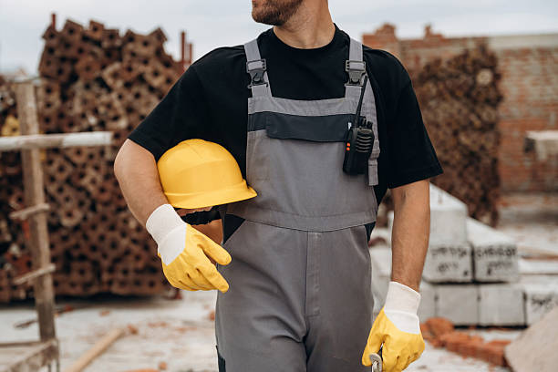 istock Safety first, holding protective helmet. Close up view of builder that is on the construction site 2242147955