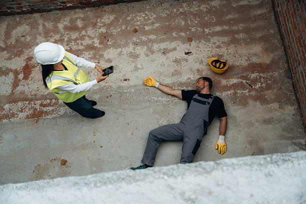 istock Man, construction worker fell from big height, lying down without consciousness, accident, woman is checking 2242148139