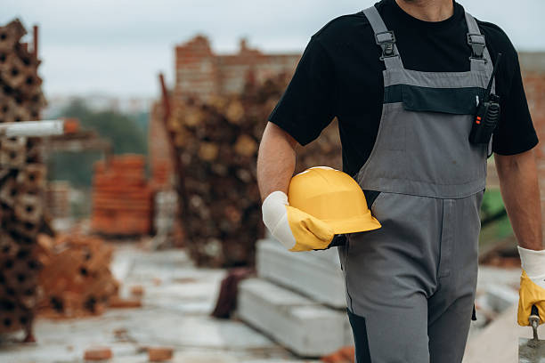 istock Safety first, holding protective helmet. Close up view of builder that is on the construction site 2242148306