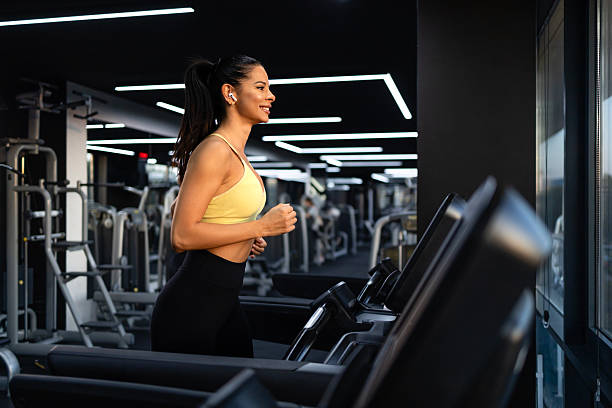 istock Female athlete running on exercising machine in the gym. 2242150186