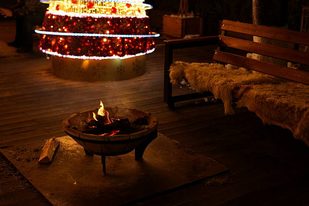 Fire bowl in the garden with stone benches around.