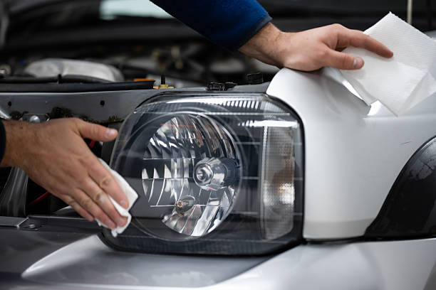 istock Mechanic hands cleaning car headlight during auto detailing 2242151294