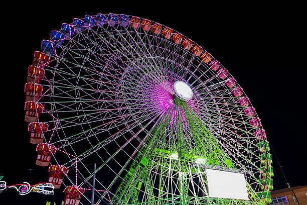 Colorful big Ferris Wheel at night in the Fair of Albacete city, Spain