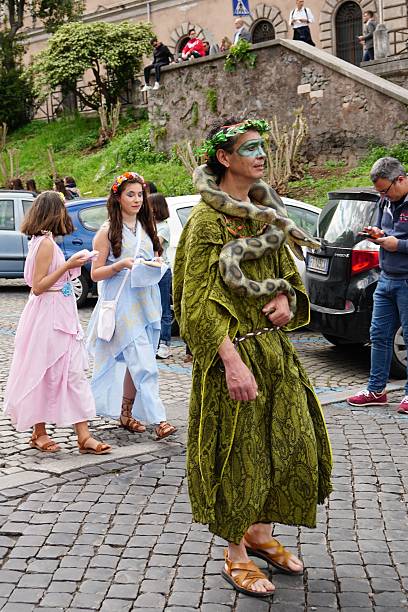 April 21, 753 BC is the official date of birth of Rome, in recent years the Municipality has promoted a spectacular event to celebrate it.Rome, Italy, April 24, 2022, celebration of the founding of Rome with hundreds of extras, here a man plays the god Mercury, followed by two maids.
