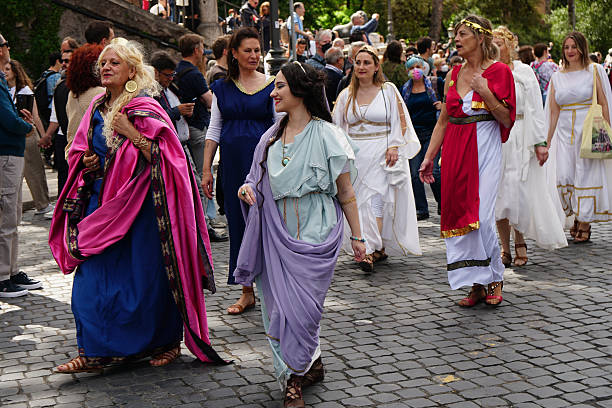 April 21, 753 BC is the official date of birth of Rome, in recent years the Municipality has promoted a spectacular event to celebrate it.Rome, Italy, April 24, 2022, celebration of the founding of Rome with hundreds of extras, here some women wearing ancient dress (the matrones), walking along Fori Imperiali avenue.