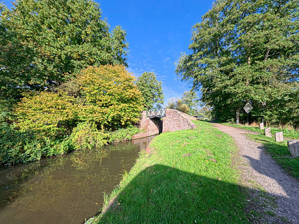 View of a British canal in autumn fall rural setting with bridge