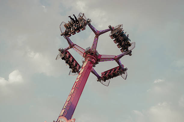 istock Moving fairground attraction with people in the air 2242162405