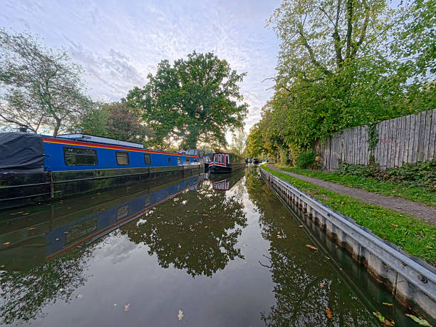 istock Narrowboat travelling on a British canal in rural setting 2242163186