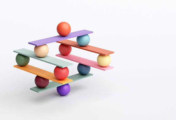 istock Balancing colored balls on colorful planks creating an unstable equilibrium 2242164842