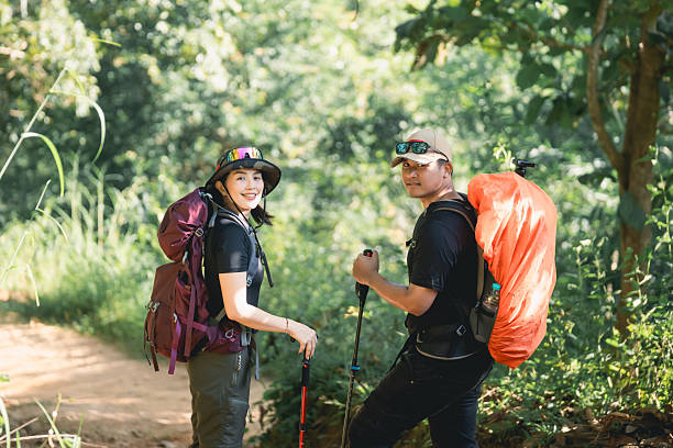 istock Enthusiastic hikers with backpacks enjoying a vibrant forest trail on a sunny day surrounded by lush greenery and nature sounds capturing adventure spirit 2242167605