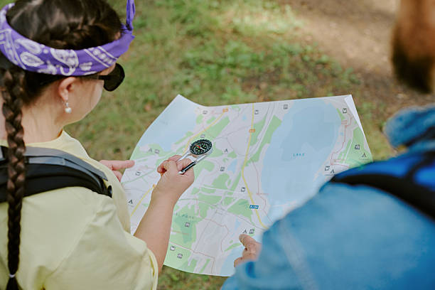 istock Young Girl with Down Syndrome Navigating Outdoor Trail with Map and Compass 2242170614