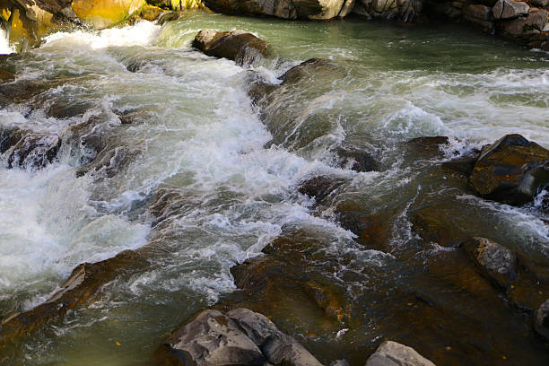 istock Rushing mountain stream with rocks and clear water flow 2242171777