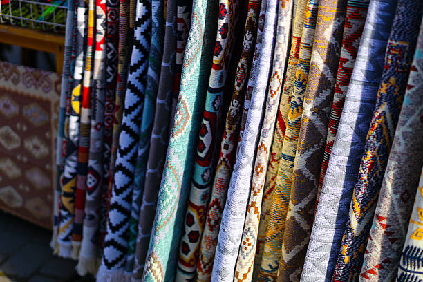istock Colorful patterned textiles displayed at outdoor market 2242172524
