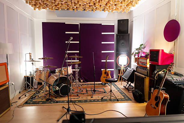 istock Professional music studio with a full set of instruments, a microphone stand, and a purple wall 2242174710