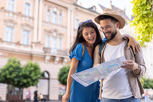 istock Joyful tourists examining a map amidst historic city scenery 2242175977