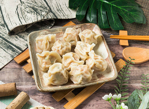 istock Steamed cabbage dumplings, beautifully arranged for a tempting meal. Perfect for food blogs, restaurant menus, or culinary projects, promising a gourmet experience. 2242184182
