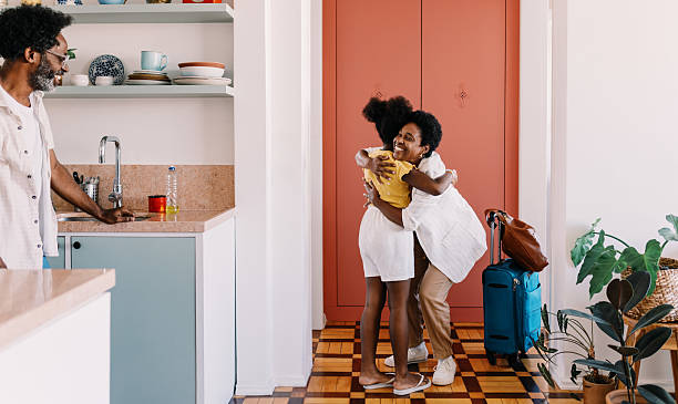 Mother arriving home to her daughter's warm welcome after travelling