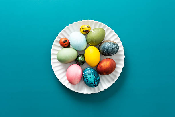 istock Festive, colorful eggs in various shades are neatly arranged on a decorative plate, symbolizing Easter traditions and spring celebrations with vibrant designs 2242185104