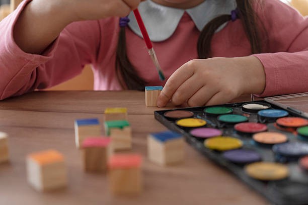 istock Girl painting cubes 2242185253
