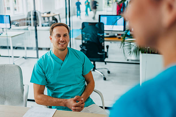 istock Healthcare workers collaborating in a modern medical clinic while providing cheerful support to patients 2242186253
