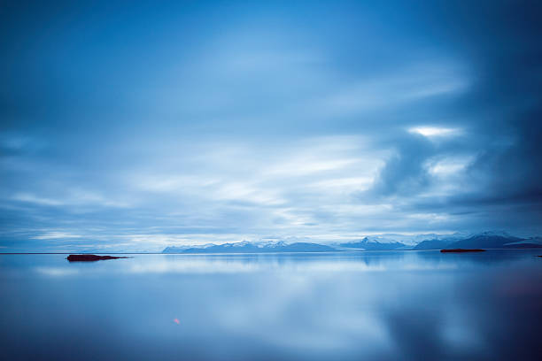 Tranquil still water in the early morning off the coast of Hofn in Iceland.