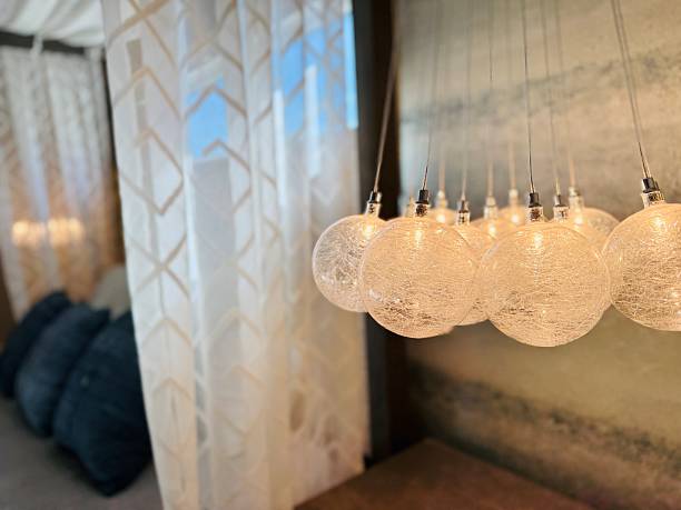 istock High-end bedroom. Modern luxury. Neutral, natural colors, texture. Canopy bed, fabric drapery, furniture, pendant lighting, pillow, decor, bedding. Small space. 2242186365