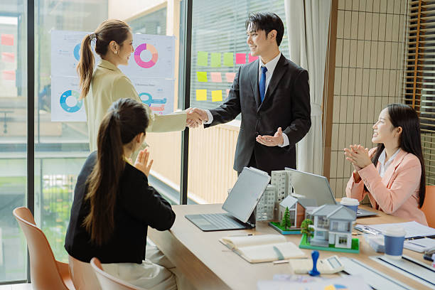 istock Celebrating success, hands raised in appreciation for real estate development, teamwork, men and women cheering, engineering and company progress. 2242186681