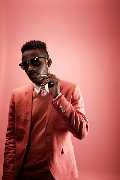 istock Portrait of Smartly Dressed Black Man Holding Cigarette 2242188704