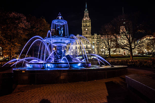 Illuminated Tourny Fountain and Quebec Parliament during night of autumn in Quebec city