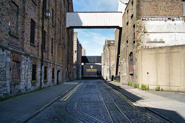 A view of the Guinness Storehouse entrance in Dublin, Ireland, showcasing historic architecture and cobblestone streets.