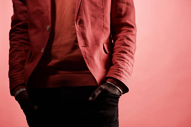 istock Anonymous Black Man in Red Suit with Hands on Pockets 2242190317