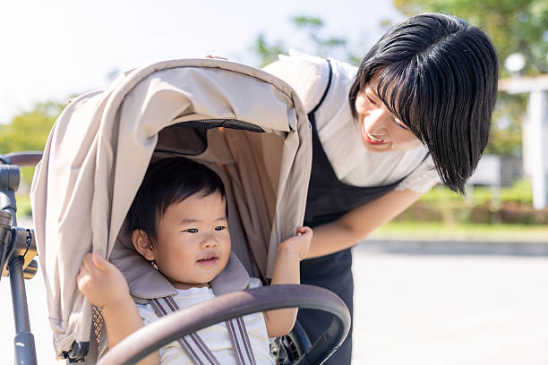 istock Mother talking to her baby son in stroller 2242191449