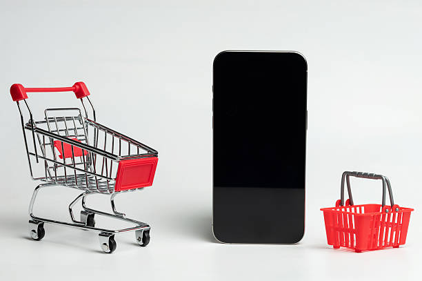 istock Online shopping concept with phone and shopping carts 2242194675