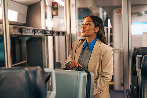 istock Woman traveling on public transit with suitcase 2242195234