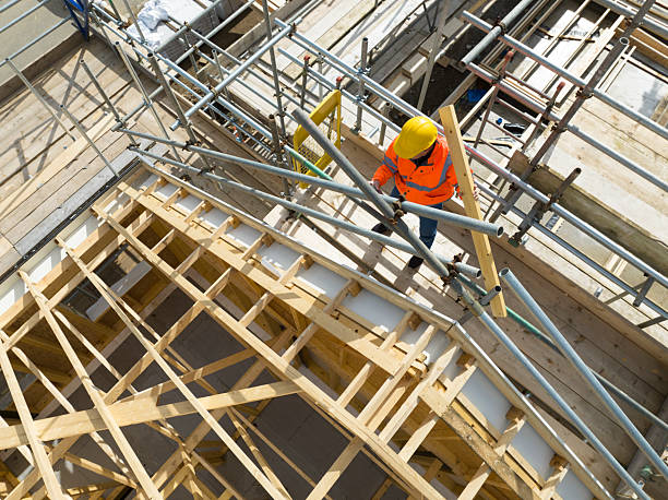 istock Aerial view of construction worker working on roof trusses 2242199959