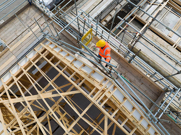 Aerial view of construction worker working on roof trusses
