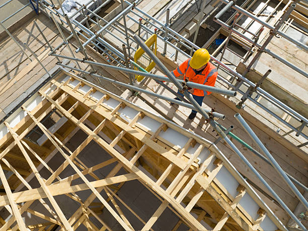 istock Aerial view of construction worker working on roof trusses 2242199965