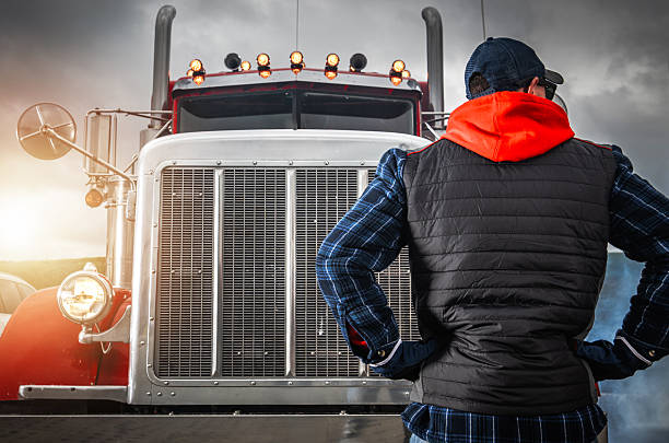istock Driver Observes the Powerful Truck Under a Dramatic Sky at Sunset 2242201395