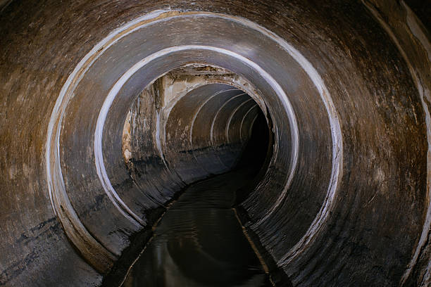 istock Industrial wastewater and urban sewage flowing through round sewer pipe 2242201787