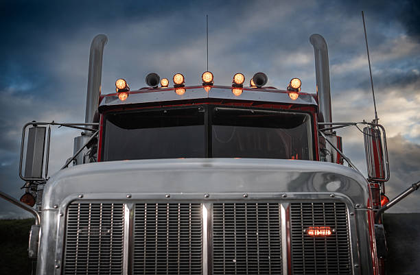 istock Truck With Shining Lights Against a Moody Sky During Twilight Hours 2242201931