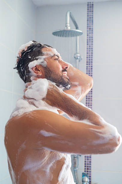 istock Young man taking a shower 2242202796
