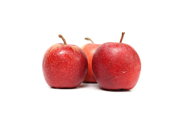 Ripe Red Apple Fruits on Clean White Surface.