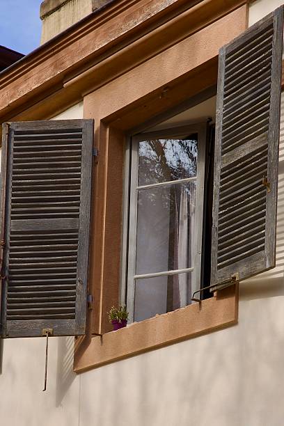 istock Open Bedroom window with faded shutters 2242209225