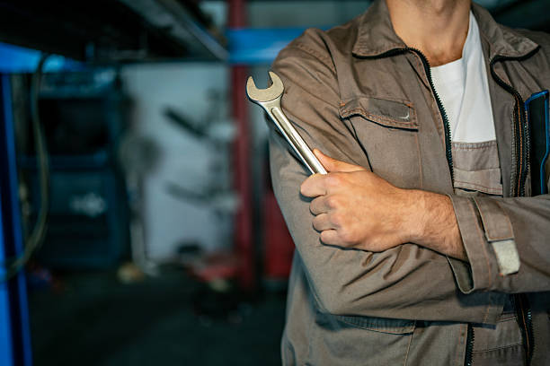 Semi Truck Pro Mechanic. Caucasian Service Worker with Heavy Duty Wrench Preparing For Complicated Truck Fix.