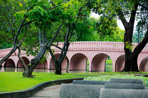 Bridge over lake behind pathway in Chatuchak Park in Bangkok