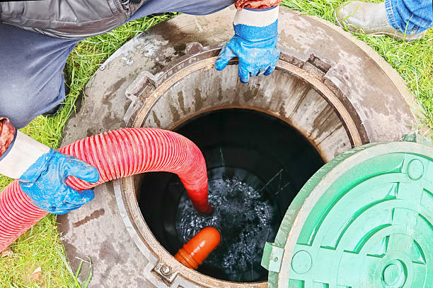 istock Septic tank service with pumping equipment in residential backyard during daylight 2242215448