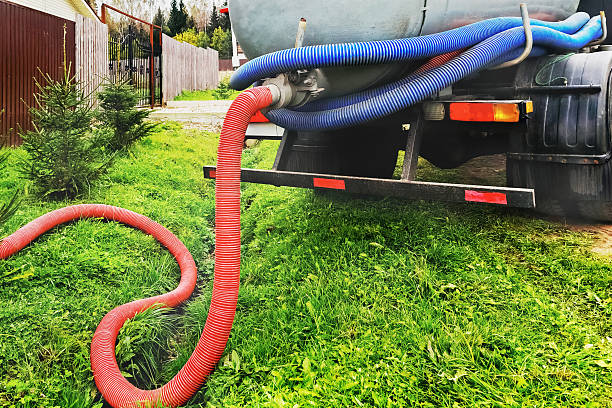 istock Sewage pumping machine. Septic tank. Pipe in a drainage pit. Pumping wastewater from a septic tank. Septic tank service equipment connected to a tank in a residential area 2242215453