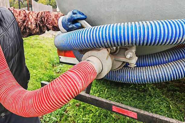 istock Sewage pumping machine.Efficient septic tank service with pumping equipment used on a residential property 2242215464