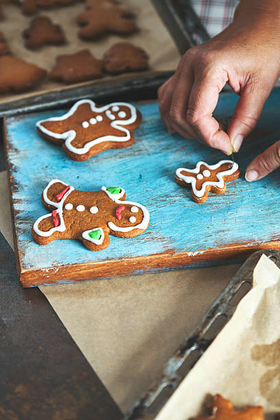 istock Decorating Gingerbread Christmas Cookies with Icing 2242217152