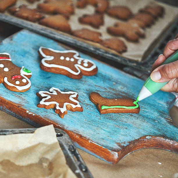 istock Decorating Gingerbread Christmas Cookies with Icing 2242217217